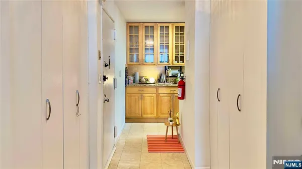 a bathroom with a sink and mirror with shower