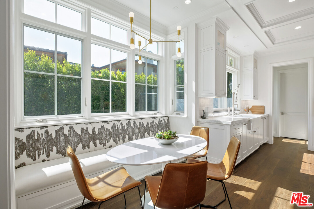 557 Chapala Drive Pacific Palisades, CA 90272 - Photo 15 of 48 a dining room with furniture and a large window