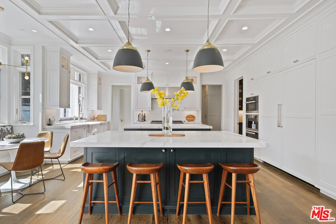 557 Chapala Drive Pacific Palisades, CA 90272 - Photo 16 of 48 a view of a dining room with furniture and wooden floor