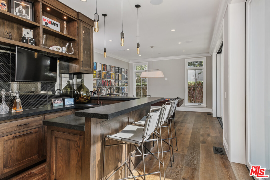 557 Chapala Drive Pacific Palisades, CA 90272 - Photo 18 of 48 a kitchen with stainless steel appliances granite countertop a kitchen island a stove and a sink