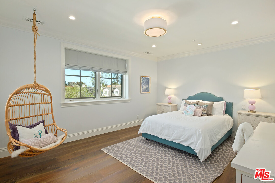 557 Chapala Drive Pacific Palisades, CA 90272 - Photo 31 of 48 a bedroom with a bed and a window