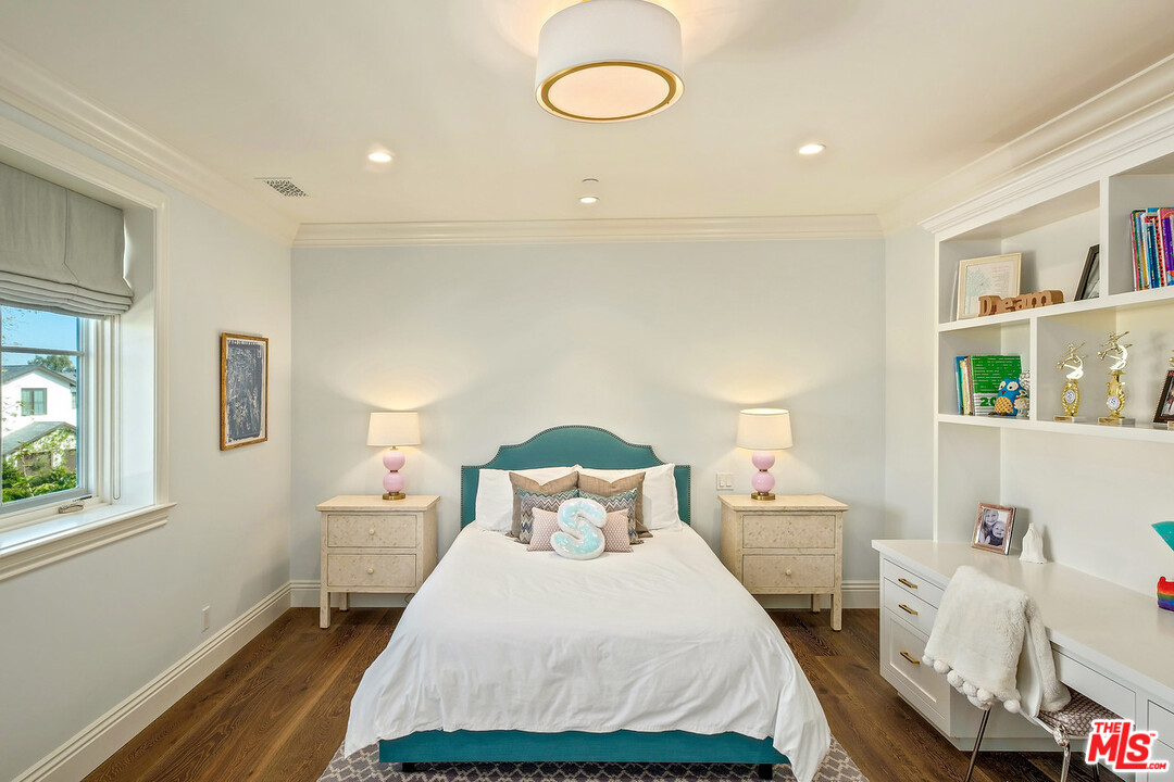 557 Chapala Drive Pacific Palisades, CA 90272 - Photo 32 of 48 a bedroom with a bed and wooden floor