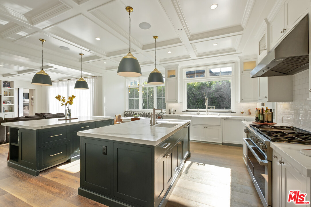 557 Chapala Drive Pacific Palisades, CA 90272 - Photo 39 of 48 a kitchen with a sink stove and wooden cabinets