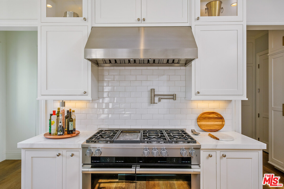 557 Chapala Drive Pacific Palisades, CA 90272 - Photo 40 of 48 a stove top oven sitting inside of a kitchen