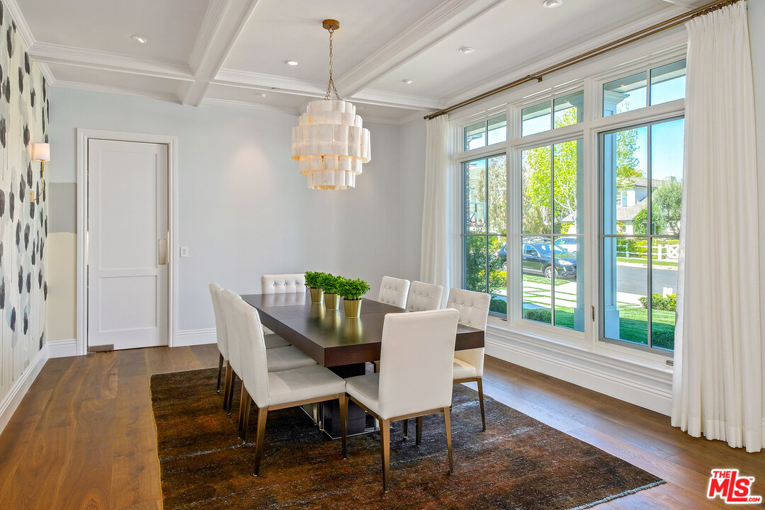 557 Chapala Drive Pacific Palisades, CA 90272 - Photo 5 of 48 a view of a dining room with furniture wooden floor and chandelier