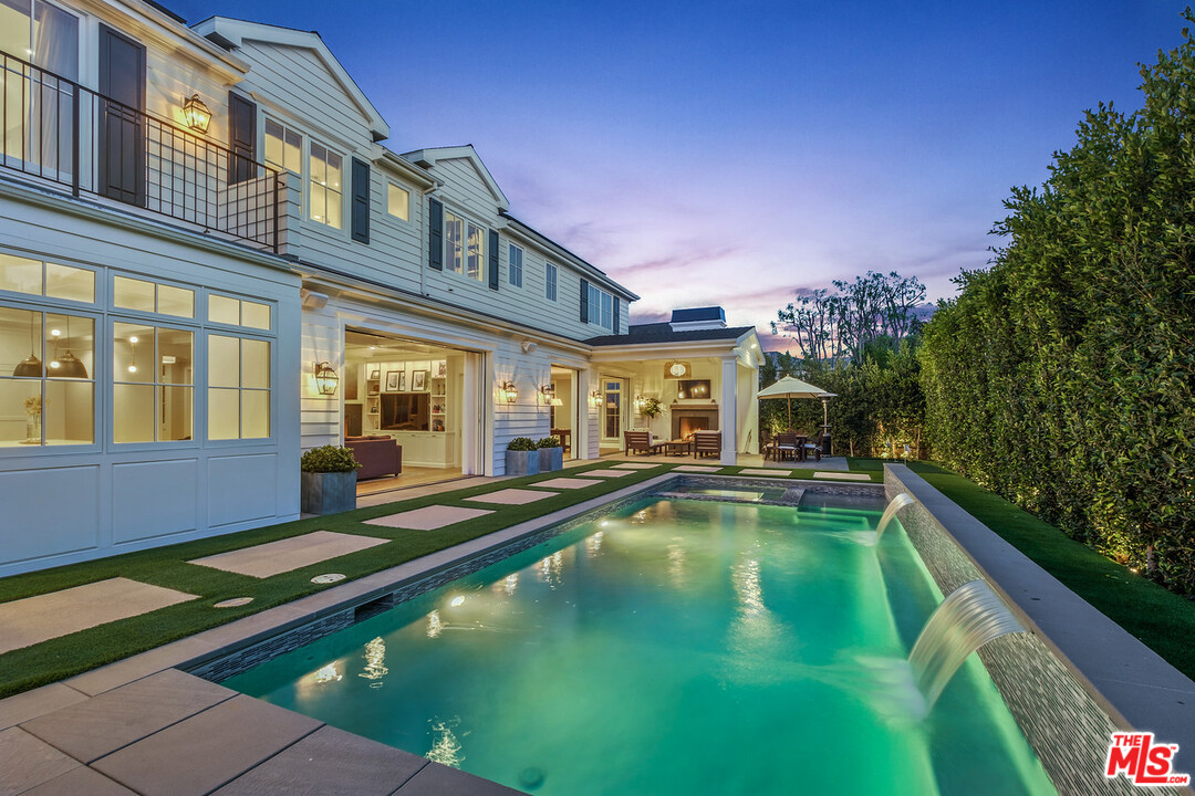 557 Chapala Drive Pacific Palisades, CA 90272 - Photo 46 of 48 a view of an house with swimming pool and porch with furniture
