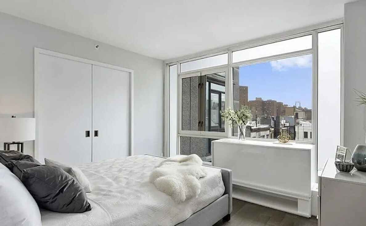 385 1st Avenue, Unit 20A Manhattan, NY 10010 - Photo 2 of 7 a bedroom with a bed and a window