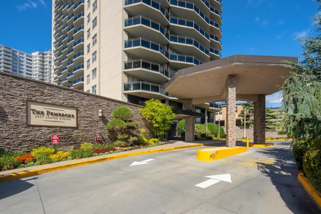 a view of a building with swimming pool and a yard