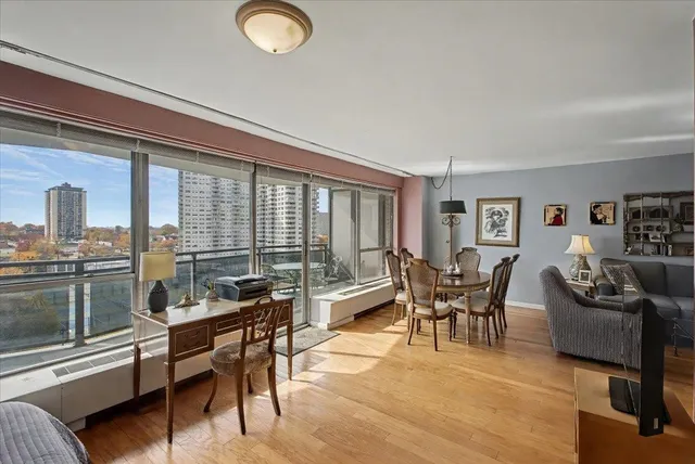 a living room with furniture and a floor to ceiling window