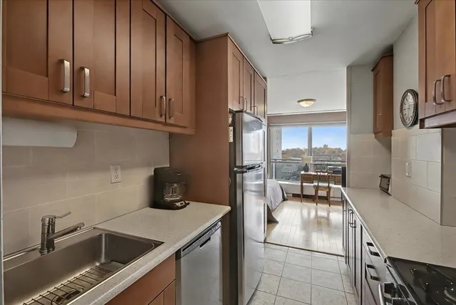 a kitchen with a sink cabinets and appliances