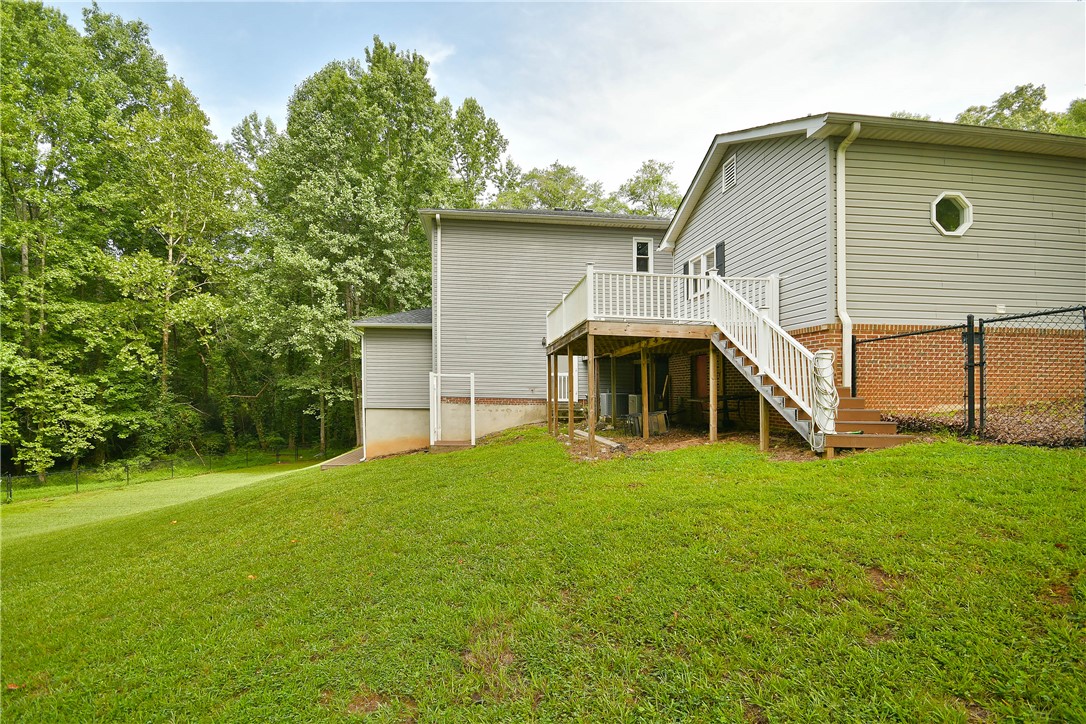 197 Deer Creek Road Easley, SC 29640 - Photo 47 of 50 A spacious backyard with mature trees provides a natural backdrop for this home's elevated deck and ample green space.