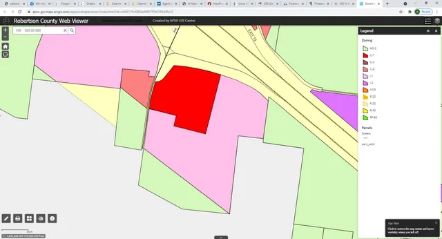 a view of a field with trees in the background