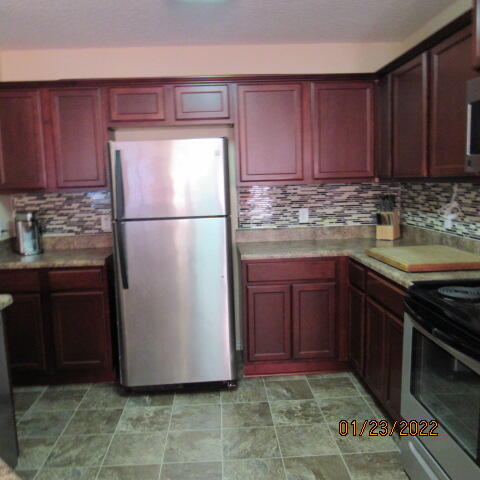 5816 Ester Terrace Crestview, FL 32539 - Photo 11 of 29 a kitchen with a refrigerator and a sink