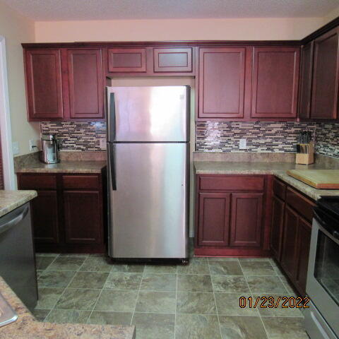 5816 Ester Terrace Crestview, FL 32539 - Photo 12 of 29 a kitchen with stainless steel appliances granite countertop a refrigerator stove top oven and sink