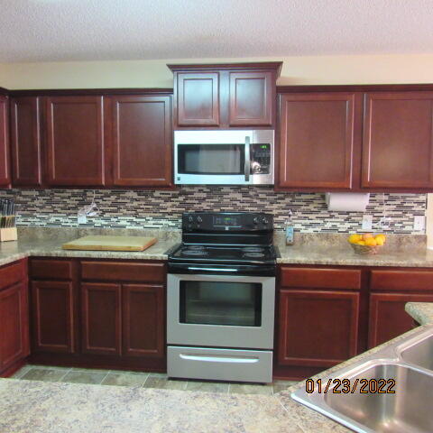 5816 Ester Terrace Crestview, FL 32539 - Photo 13 of 29 a kitchen with sink cabinets and stainless steel appliances