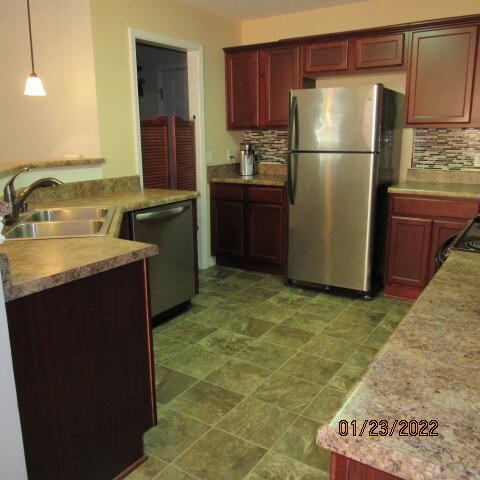 5816 Ester Terrace Crestview, FL 32539 - Photo 9 of 29 a kitchen with a sink refrigerator and cabinets