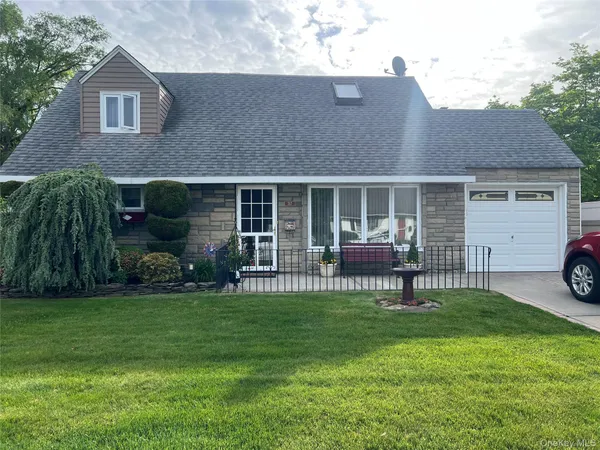 a front view of a house with a garden