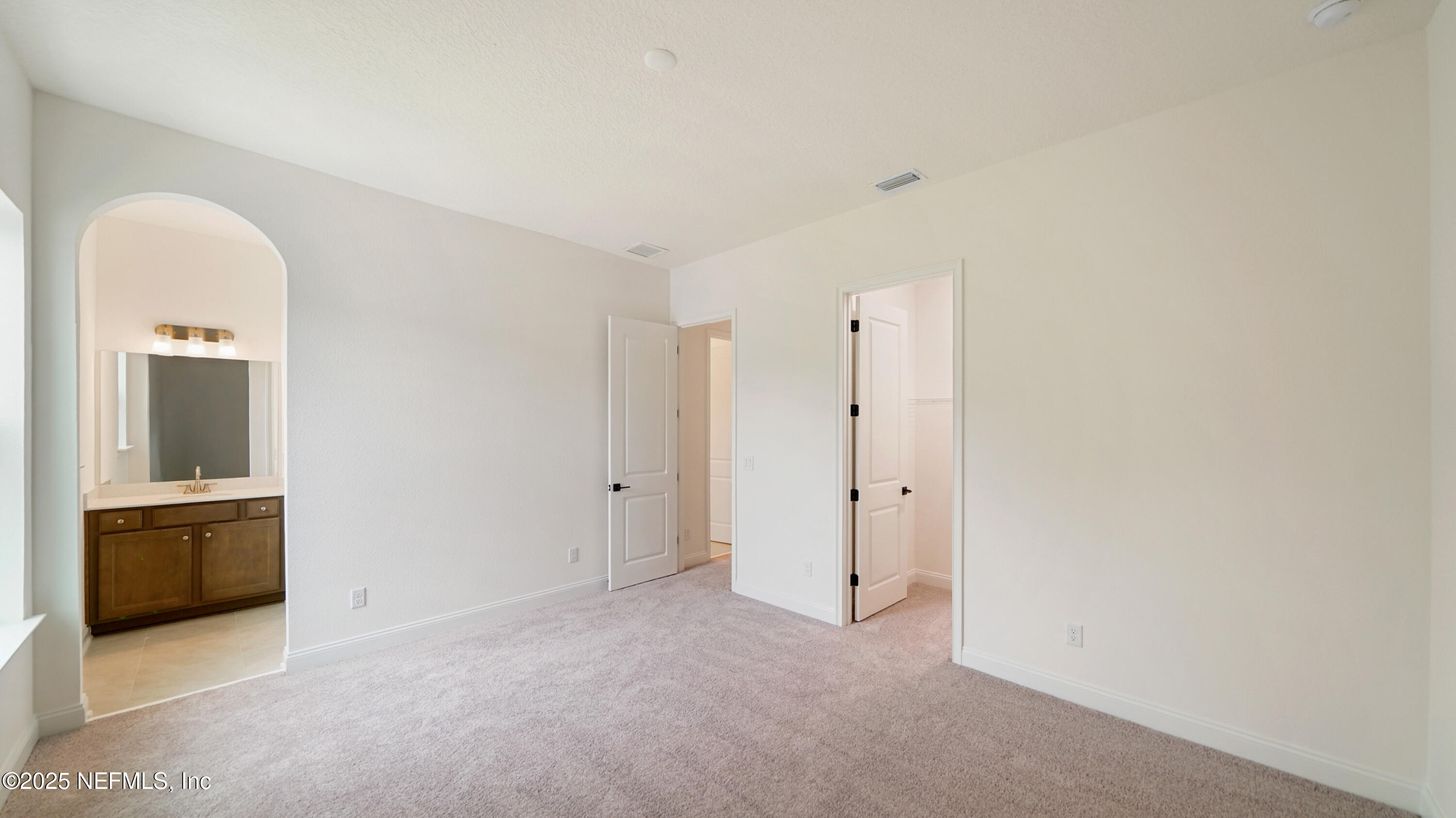 3137 Spiro Circle Jacksonville, FL 32246 - Photo 42 of 84 an empty room with closet and mirror