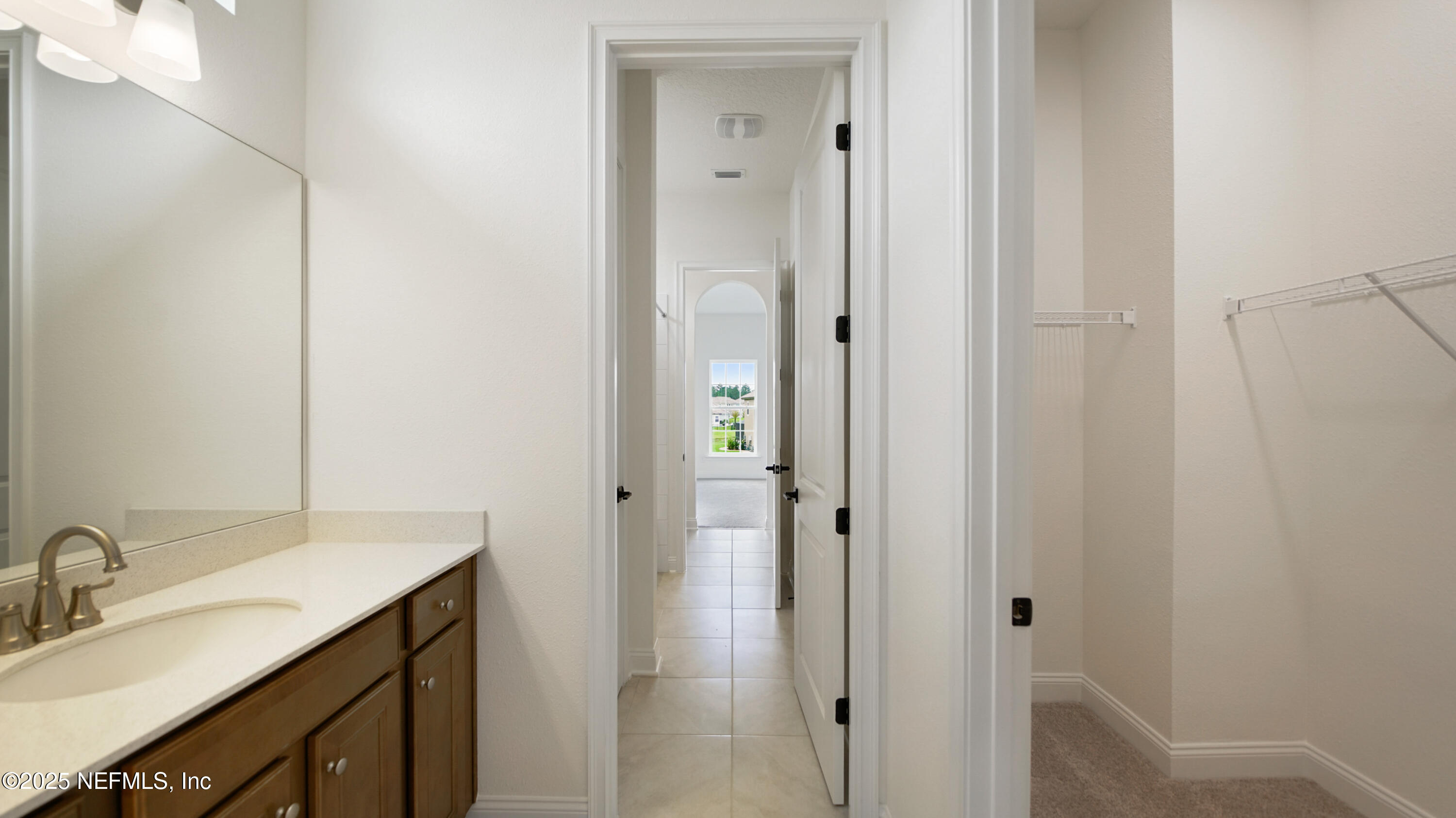 3137 Spiro Circle Jacksonville, FL 32246 - Photo 51 of 84 a bathroom with a double vanity sink and mirror