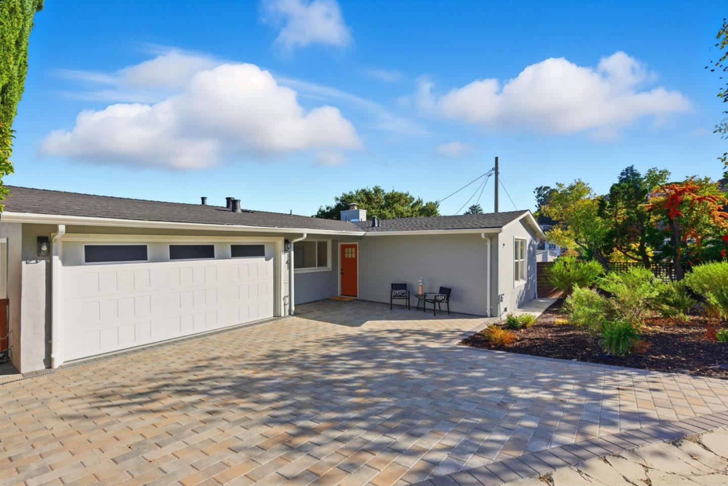 a view of a house with a backyard and a garage