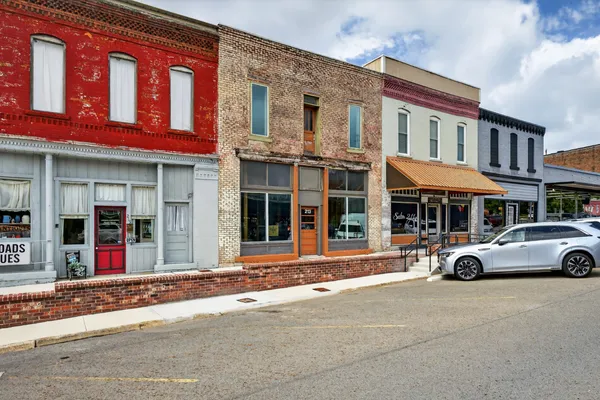 an aerial view of a house with table and chairs