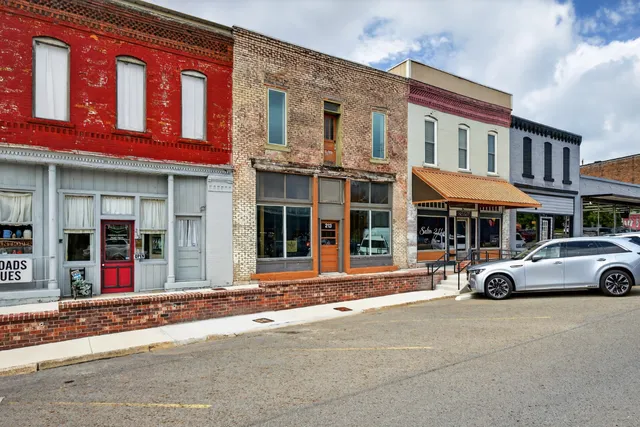an aerial view of a house with table and chairs