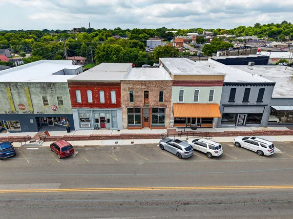 an aerial view of a houses with city view