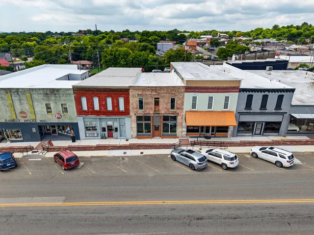 an aerial view of a houses with city view