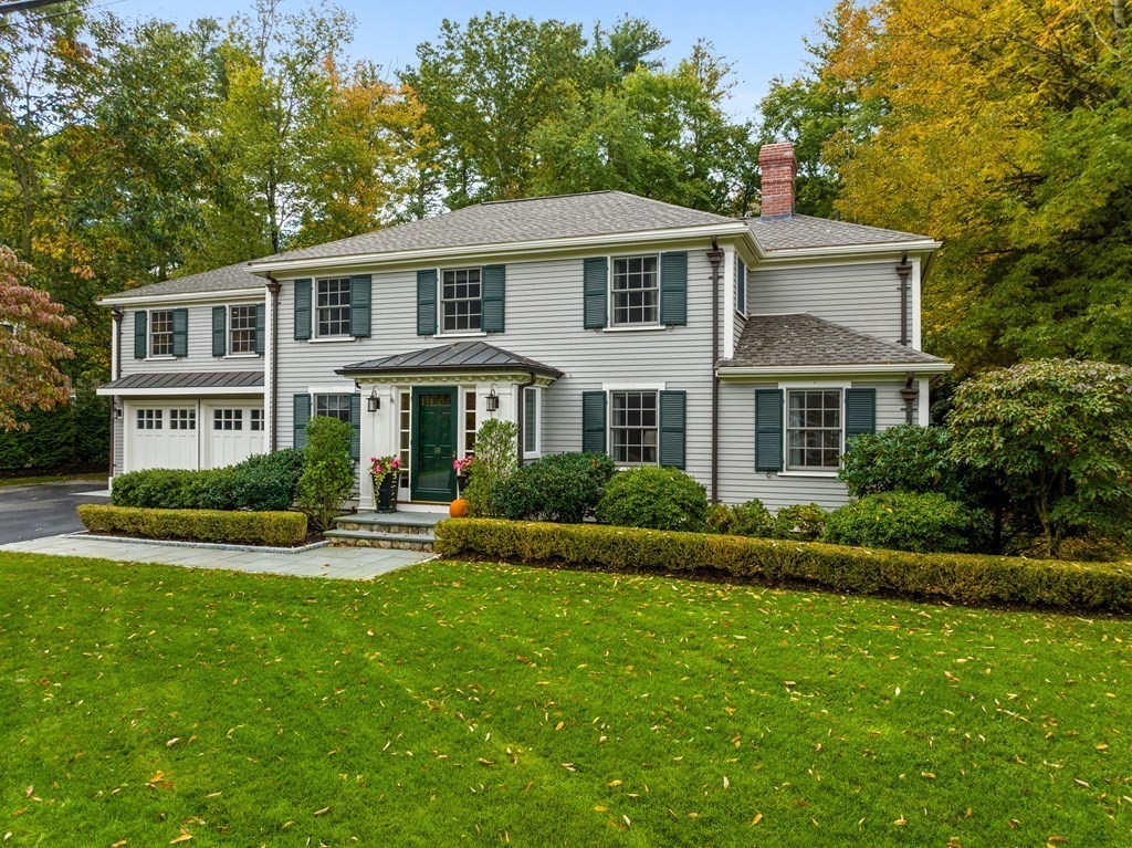 a front view of a house with a yard and porch