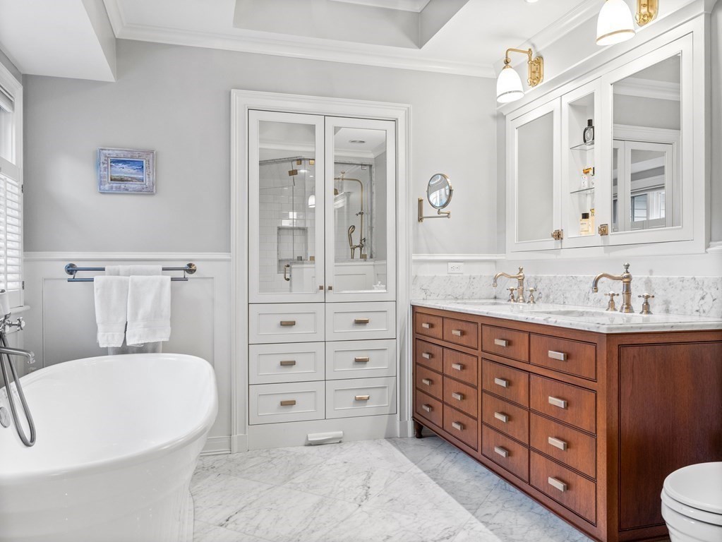19 Radcliffe Road Wellesley, MA 02482 - Photo 13 of 21 a bathroom with a tub sink double vanity and mirror