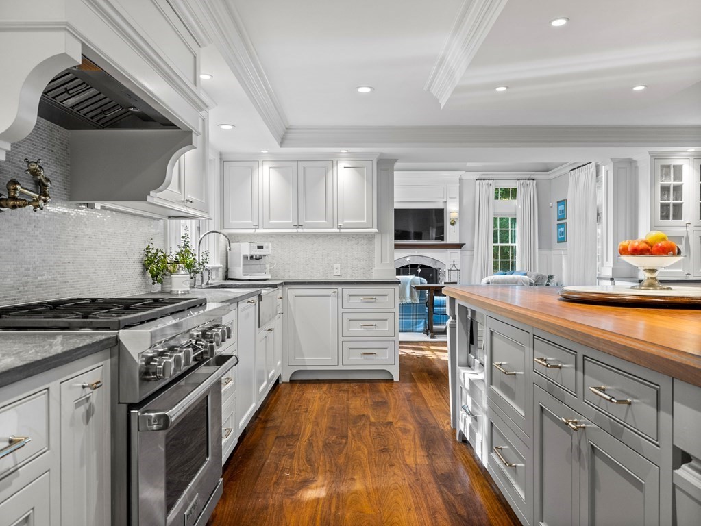19 Radcliffe Road Wellesley, MA 02482 - Photo 4 of 21 a kitchen with white cabinets and appliances