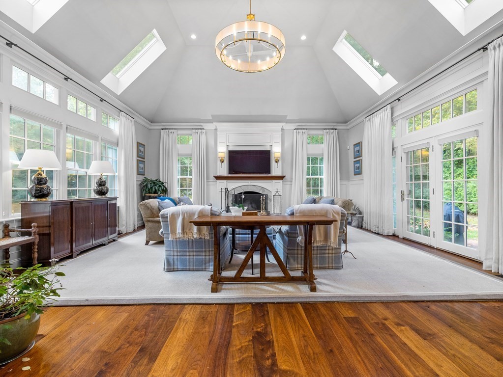 19 Radcliffe Road Wellesley, MA 02482 - Photo 6 of 21 a living room with furniture a fireplace and a floor to ceiling window