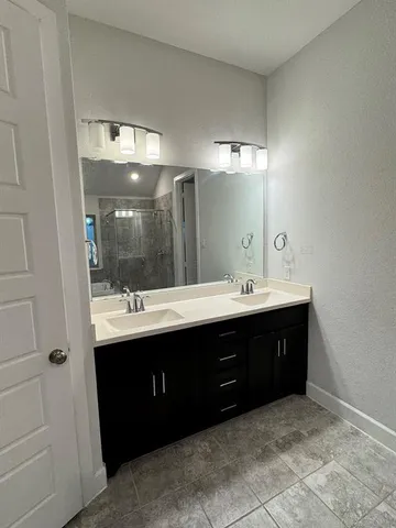 a bathroom with a sink vanity and a mirror
