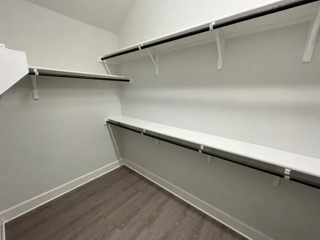 a view of a room with wooden floor