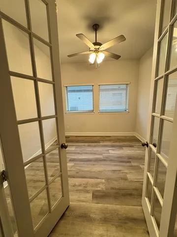 a kitchen with stainless steel appliances granite countertop a sink a kitchen island a refrigerator and wooden floor