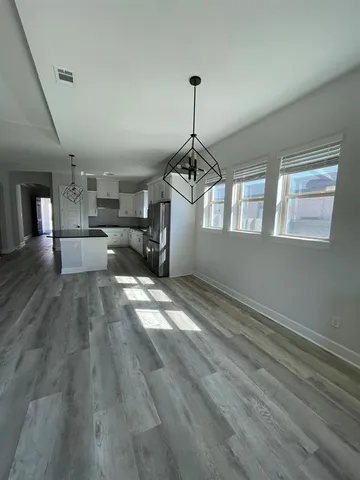 a view of a kitchen with a sink dishwasher stove and cabinets