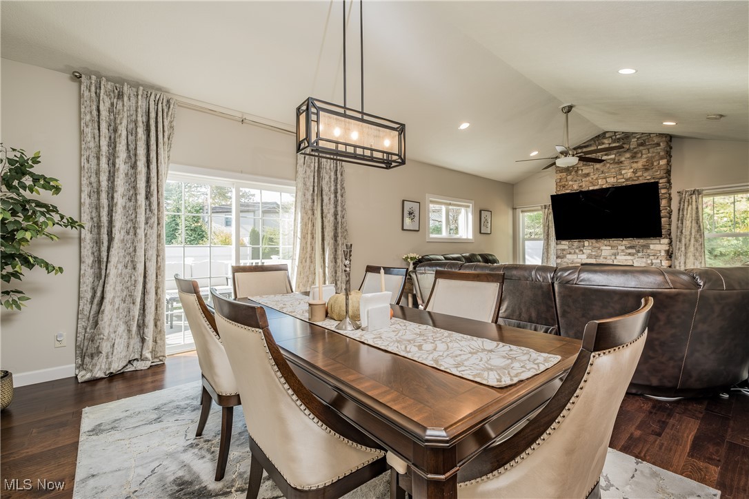 Dining area with lofted ceiling, dark wood-type flooring, and ceiling fan