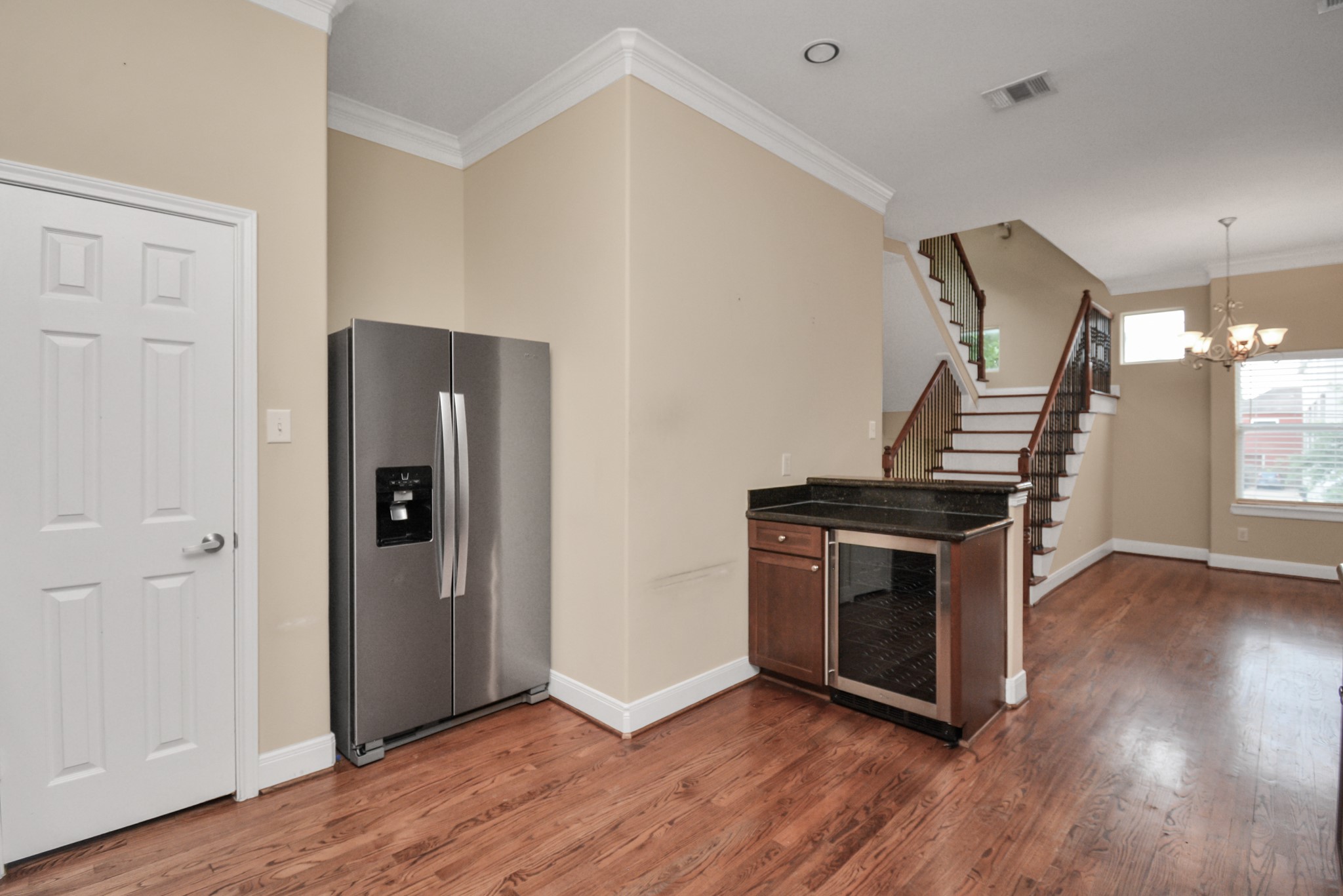 1137 West 24th Street, Unit A Houston, TX 77008 - Photo 14 of 40 a view of an empty room with a kitchen and wooden floor