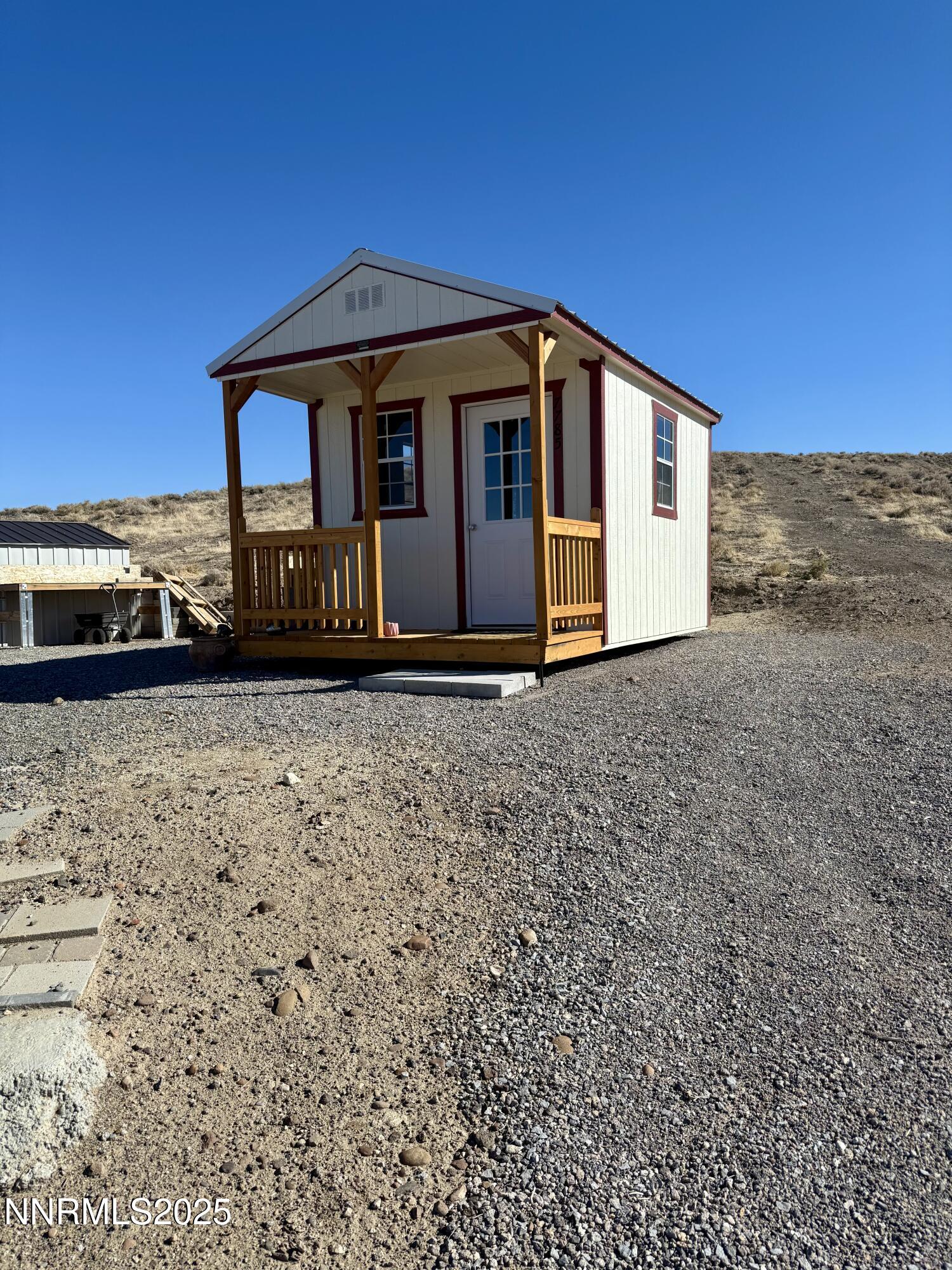 7785 Desert Shadows Lane Fernley, NV 89408 - Photo 10 of 21 a front view of a house with a yard