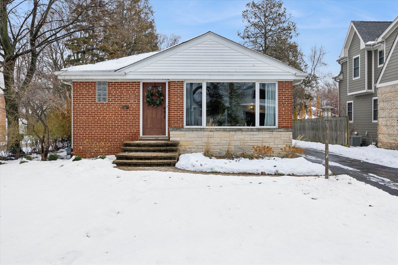 309 Clinton Avenue Elmhurst, IL 60126 - Photo 1 of 33 a front view of a house with a yard covered in snow