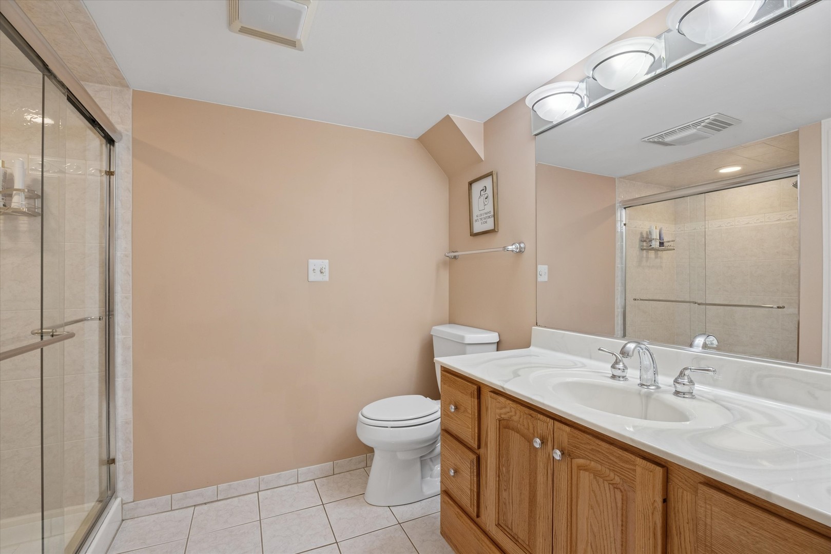 309 Clinton Avenue Elmhurst, IL 60126 - Photo 28 of 33 a spacious bathroom with a granite countertop sink a toilet and a mirror