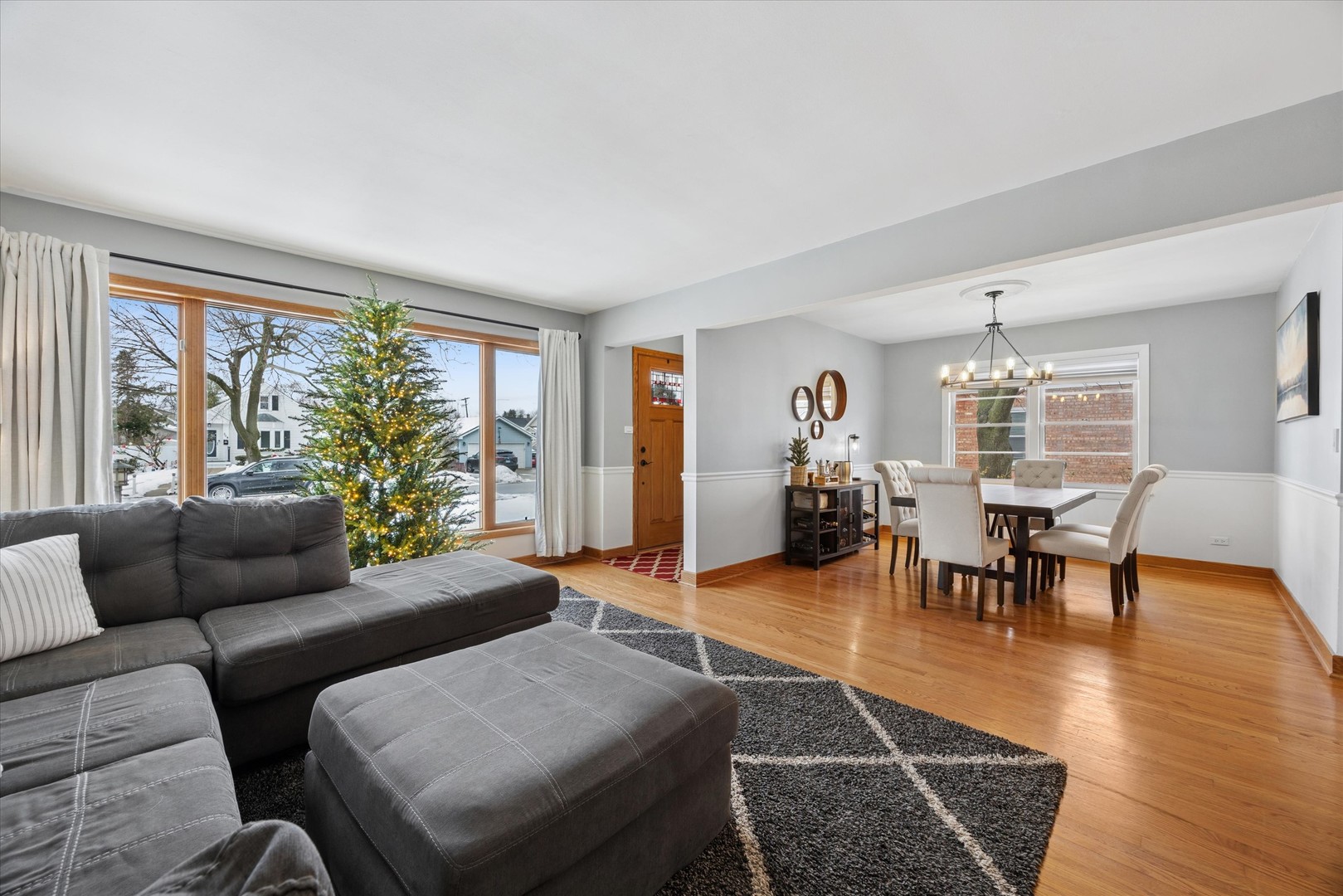309 Clinton Avenue Elmhurst, IL 60126 - Photo 7 of 33 a living room with furniture and a chandelier