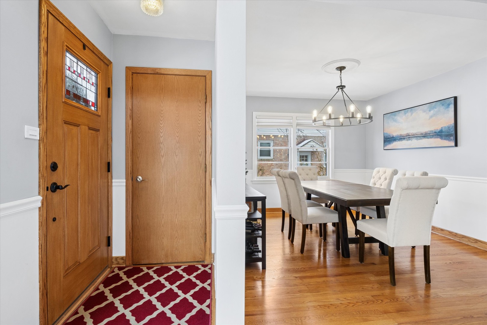 309 Clinton Avenue Elmhurst, IL 60126 - Photo 9 of 33 a view of a dining room with furniture a chandelier and wooden floor