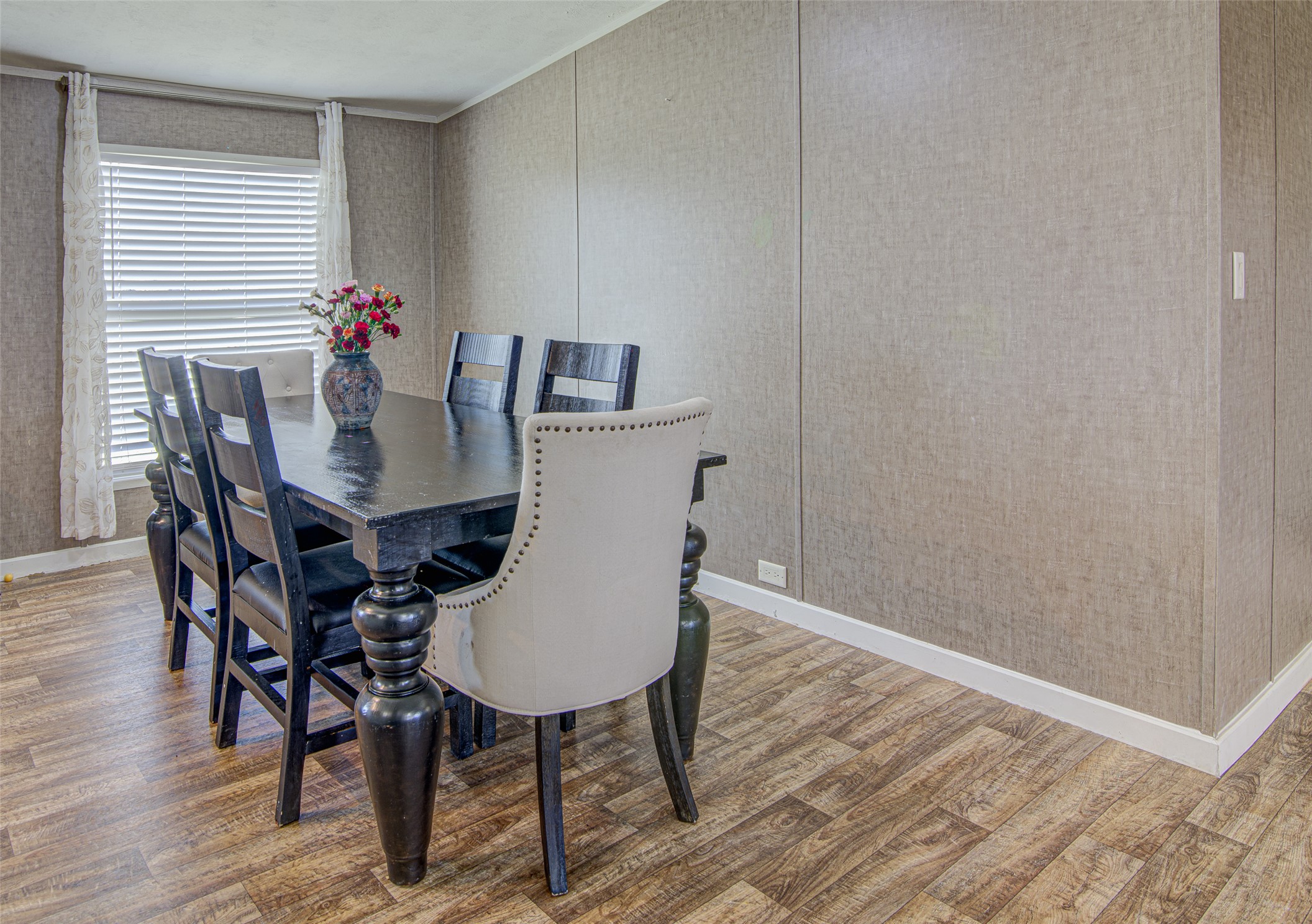 445 Rancho Linda Drive Lockhart, TX 78644 - Photo 15 of 26 A well-lit dining area featuring rich wooden-style flooring and natural light from a window.