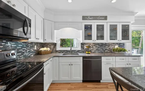a kitchen with stainless steel appliances granite countertop a stove and a sink