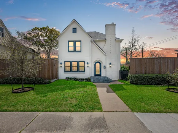 a kitchen with stainless steel appliances granite countertop a refrigerator a sink dishwasher a stove and white cabinets with wooden floor