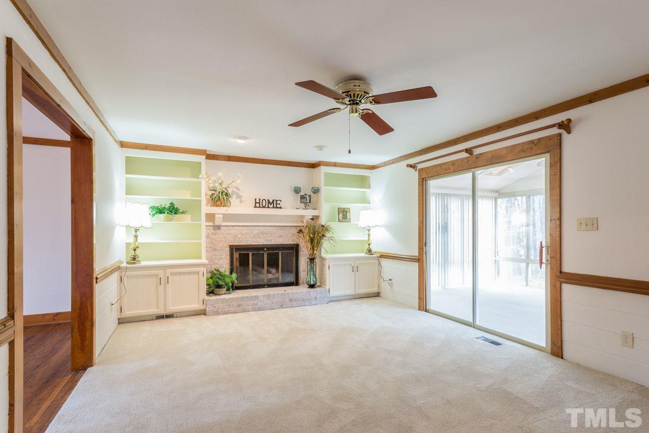 10405 Boxelder Drive Raleigh, NC 27613 - Photo 9 of 25 New carpet, gas log fireplace surrounded by built in bookcases.
