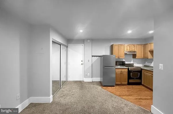 a view of a kitchen with refrigerator and microwave