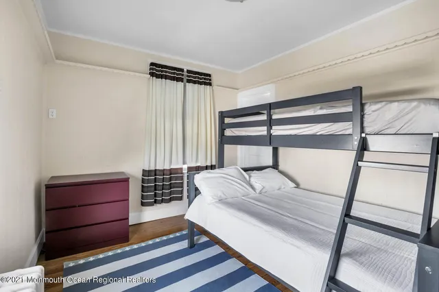 a bedroom with two beds and a window