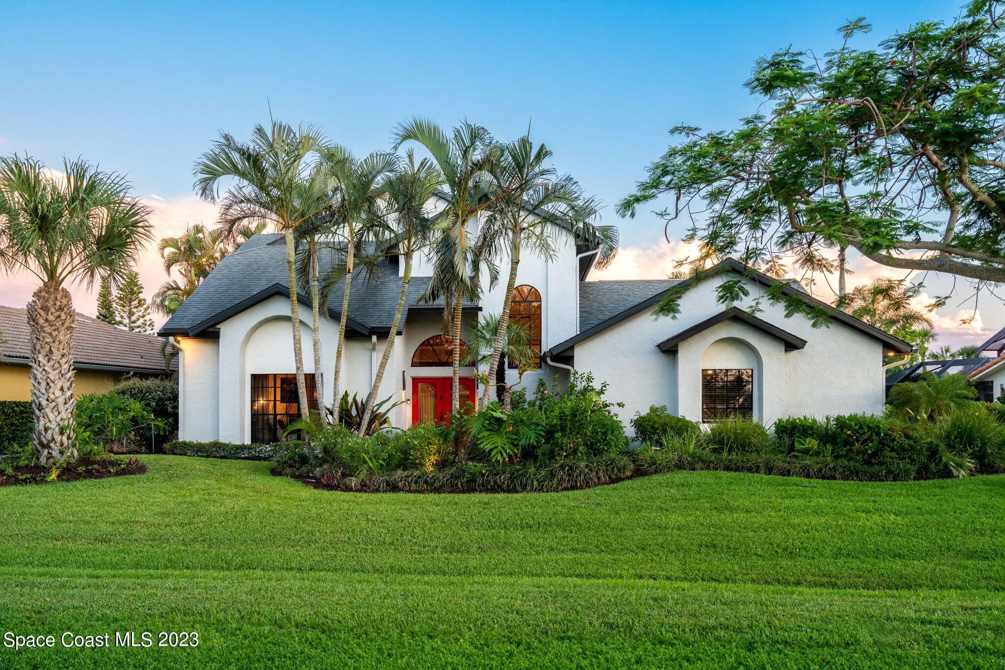 a front view of a house with a garden